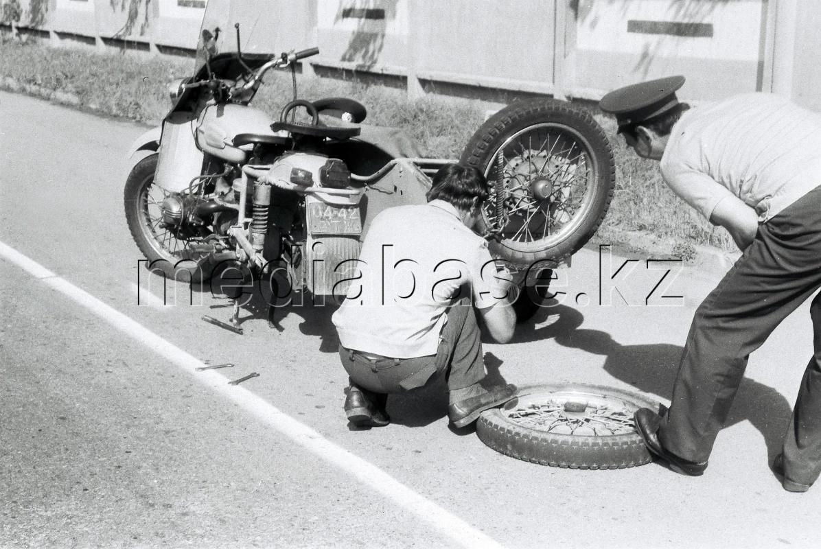The motorcycle is being repaired by the roadside. - photo 1