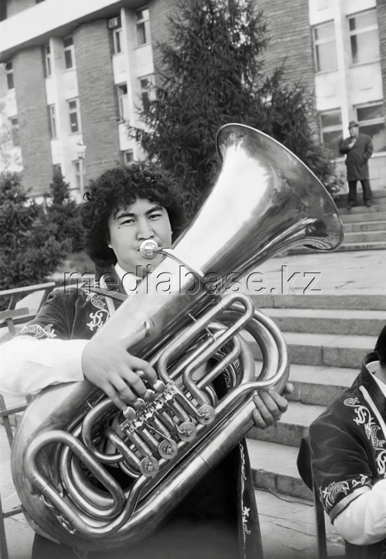 Звук степи: Молодой музыкант на духовых инструментах в национальном костюме - фото 1